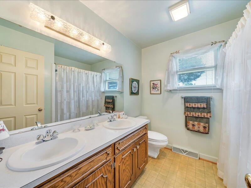 1091 Cool Rock Road Vinton, VA 24179 - Photo 27 of 44 a bathroom with a sink double vanity and a toilet