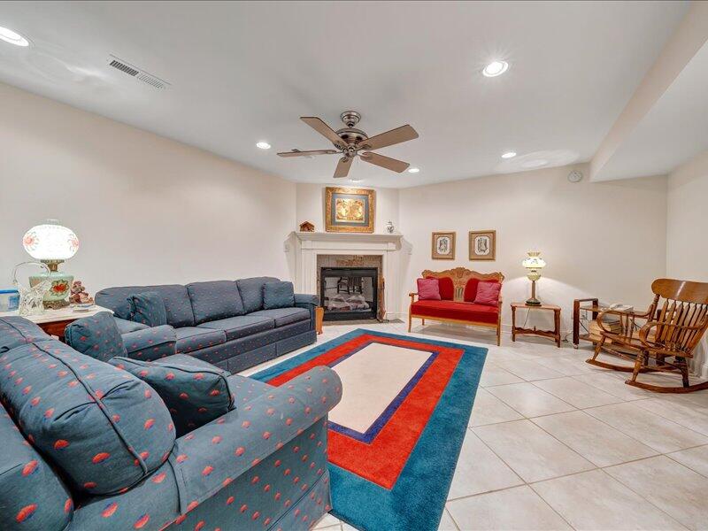 1091 Cool Rock Road Vinton, VA 24179 - Photo 28 of 44 a living room with furniture a fireplace and a chandelier
