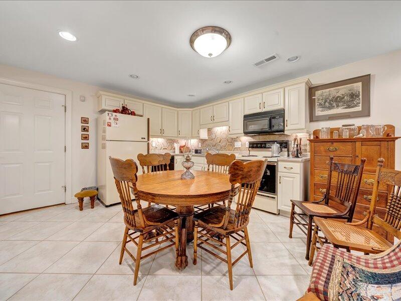1091 Cool Rock Road Vinton, VA 24179 - Photo 29 of 44 a view of a dining room with furniture and a refrigerator