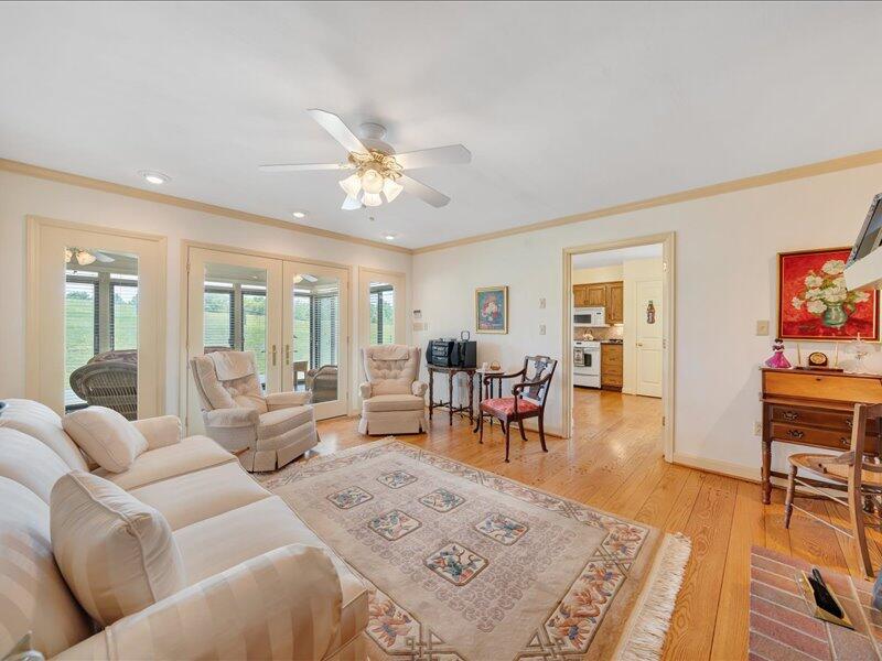 1091 Cool Rock Road Vinton, VA 24179 - Photo 9 of 44 a living room with furniture two wooden floor and a rug