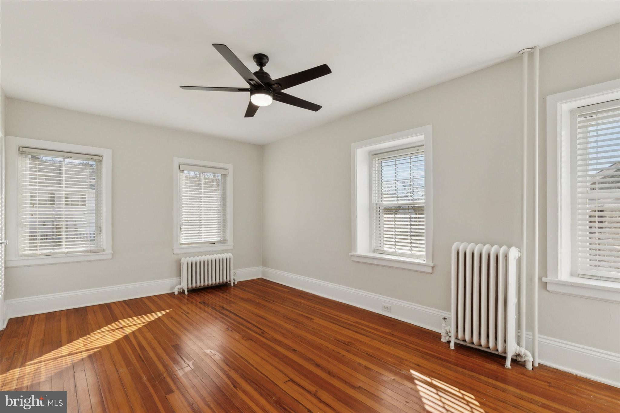 1329 Olive Street Coatesville, PA 19320 - Photo 21 of 35 a view of empty room with wooden floor and fan