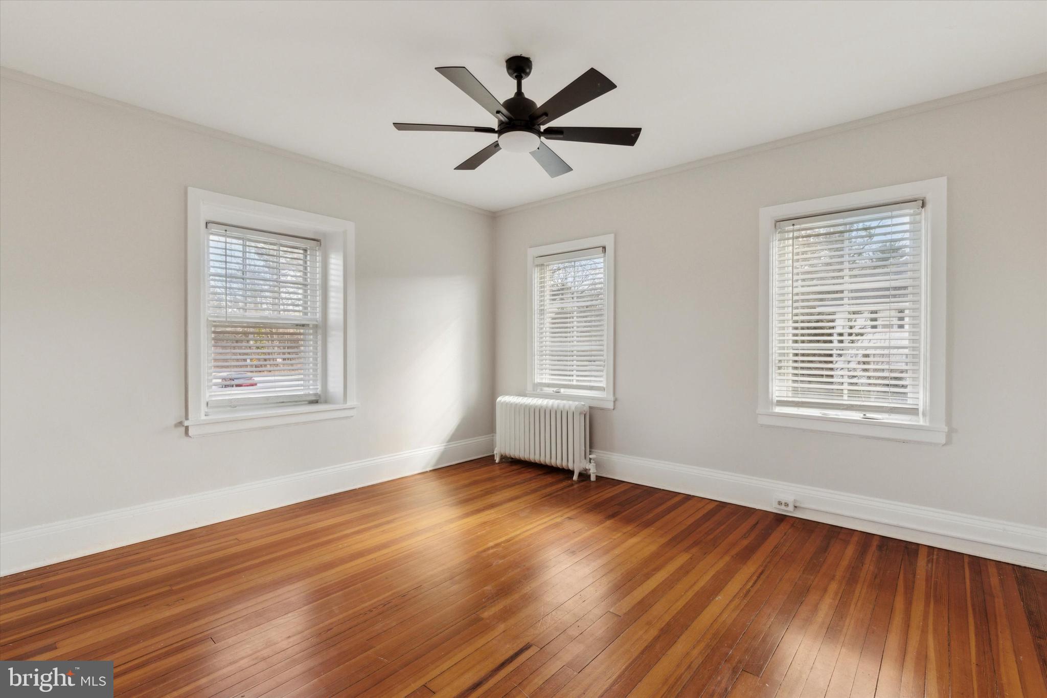 1329 Olive Street Coatesville, PA 19320 - Photo 23 of 35 a view of empty room with wooden floor and fan