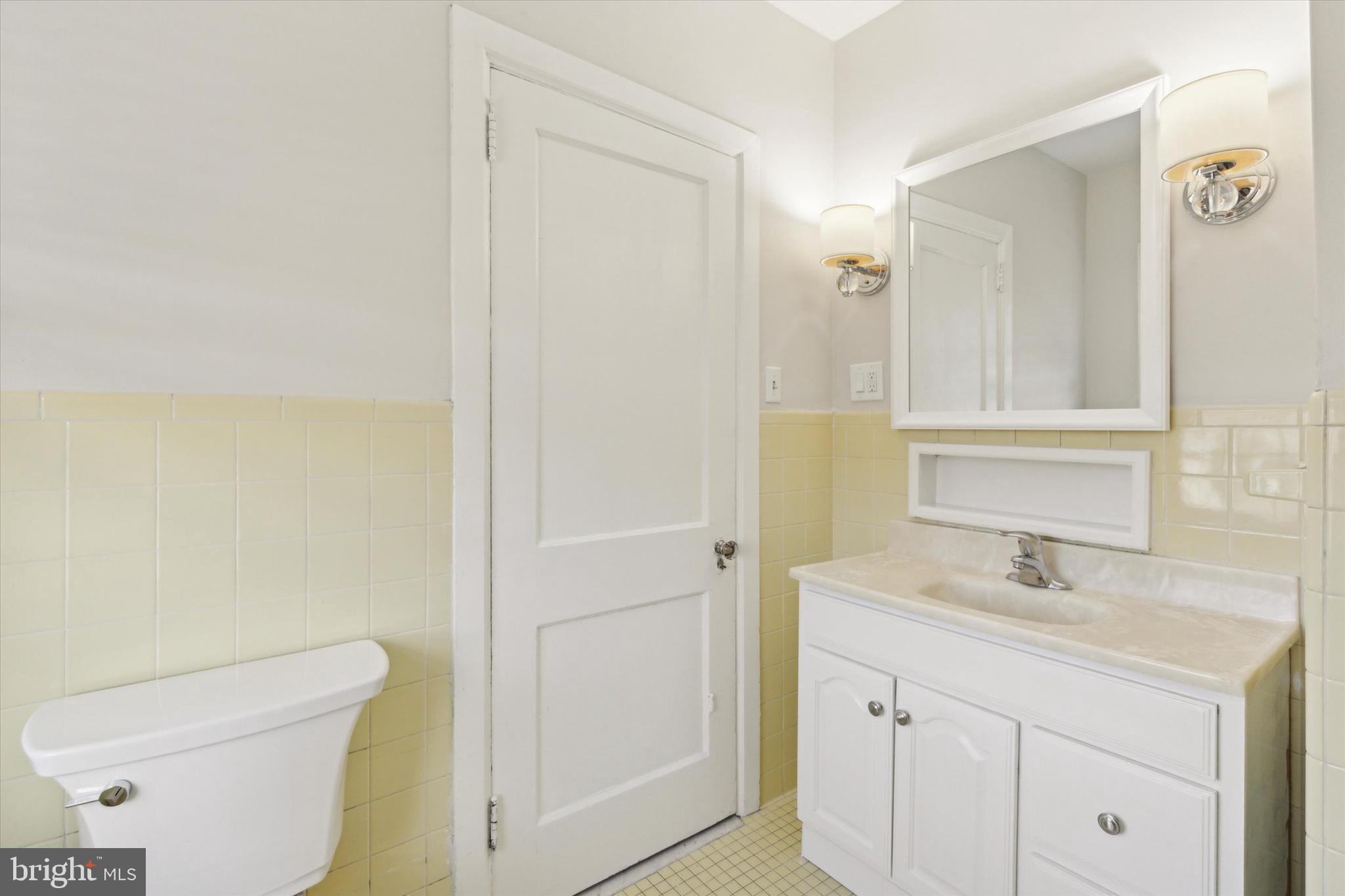 1329 Olive Street Coatesville, PA 19320 - Photo 25 of 35 a bathroom with a sink a toilet a shower and a mirror