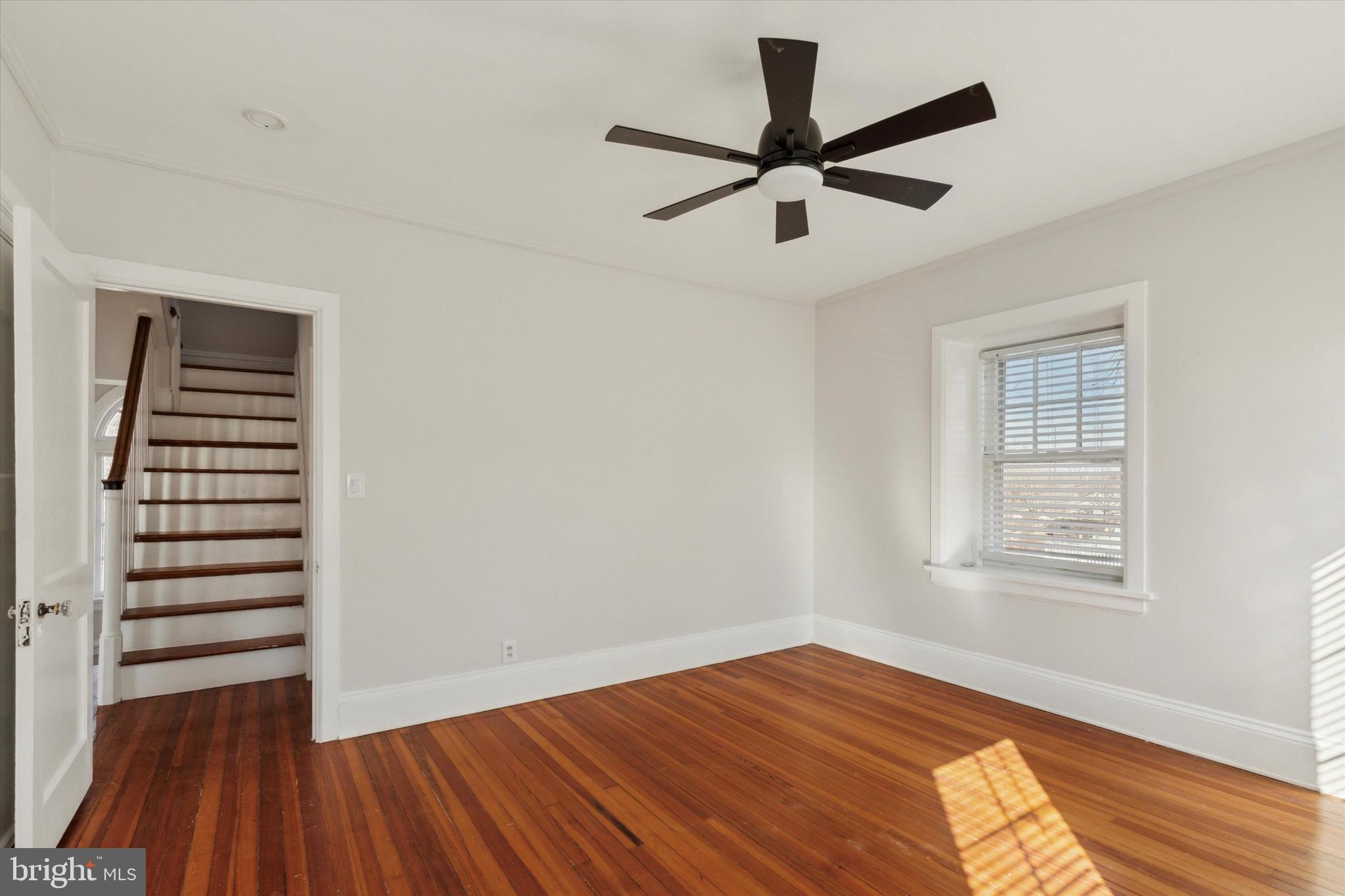 1329 Olive Street Coatesville, PA 19320 - Photo 27 of 35 a view of empty room with wooden floor and fan