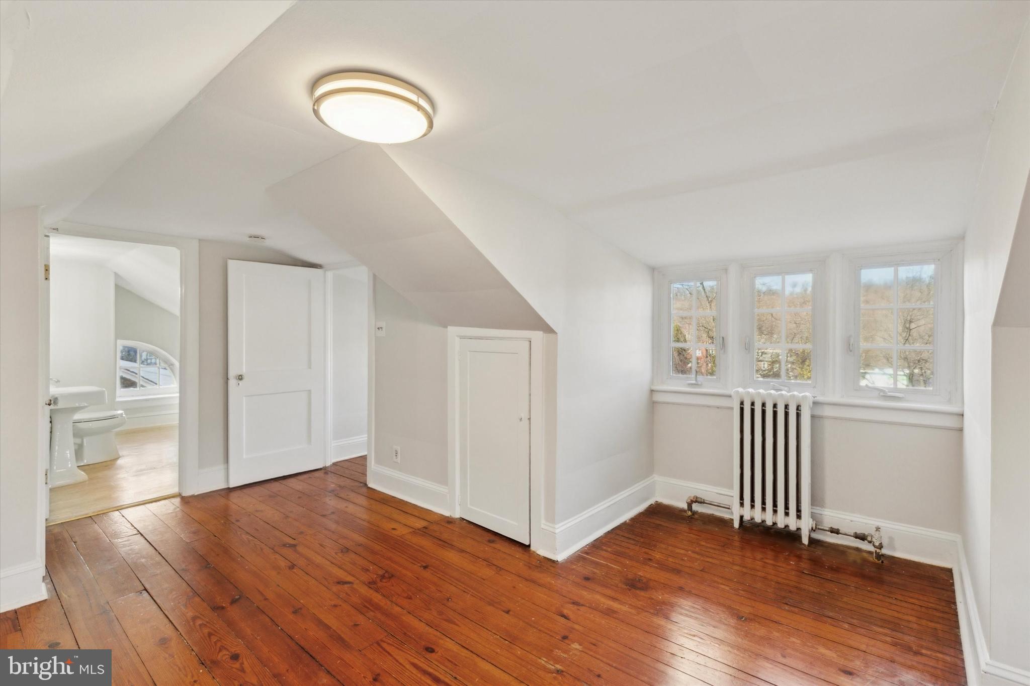 1329 Olive Street Coatesville, PA 19320 - Photo 29 of 35 a view of empty room with wooden floor and fan