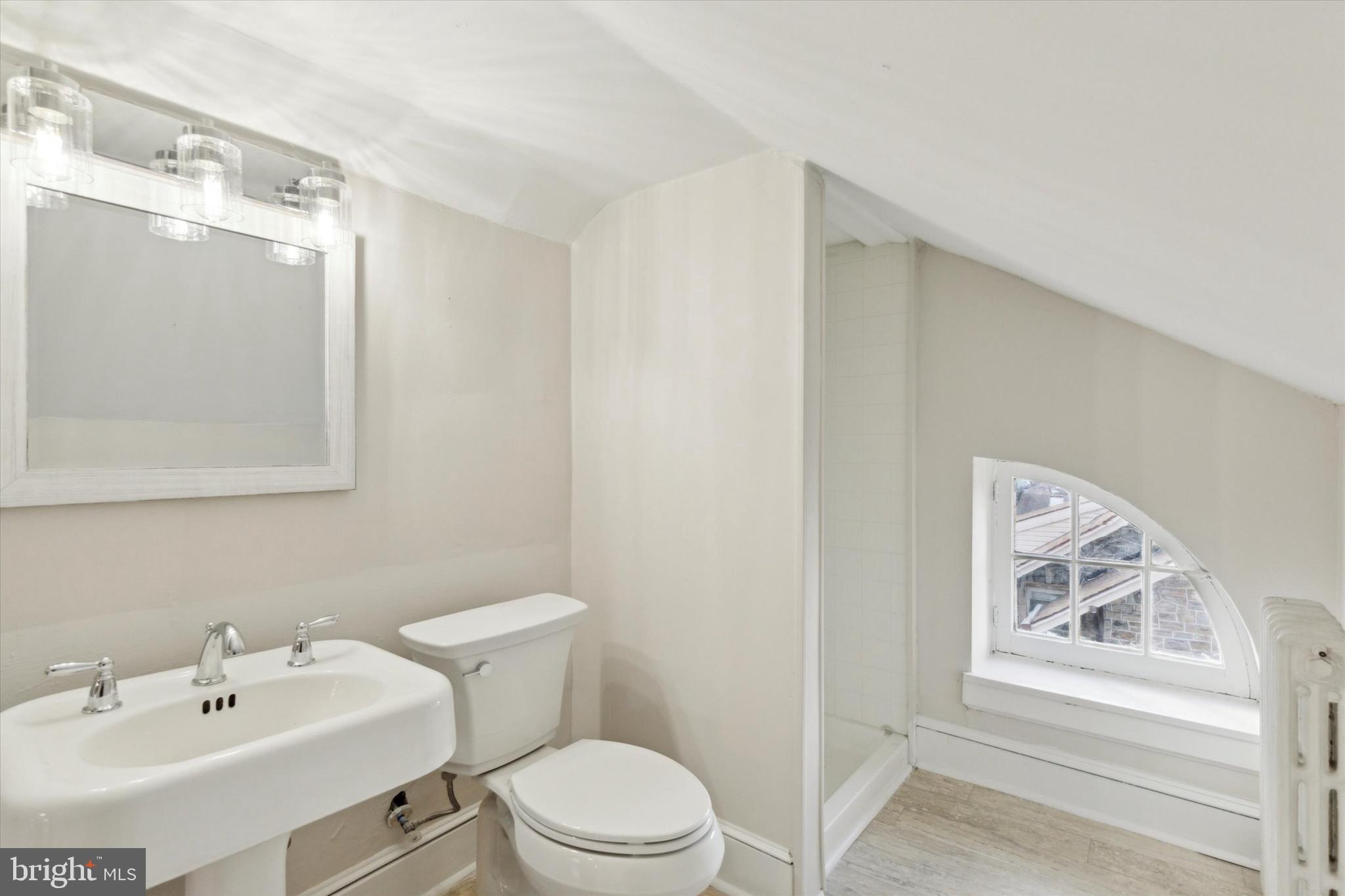 1329 Olive Street Coatesville, PA 19320 - Photo 30 of 35 a bathroom with a sink mirror and toilet