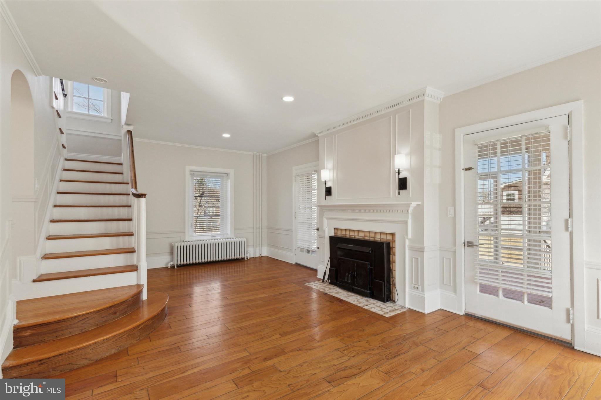1329 Olive Street Coatesville, PA 19320 - Photo 6 of 35 a view of an empty room with wooden floor fireplace and a window