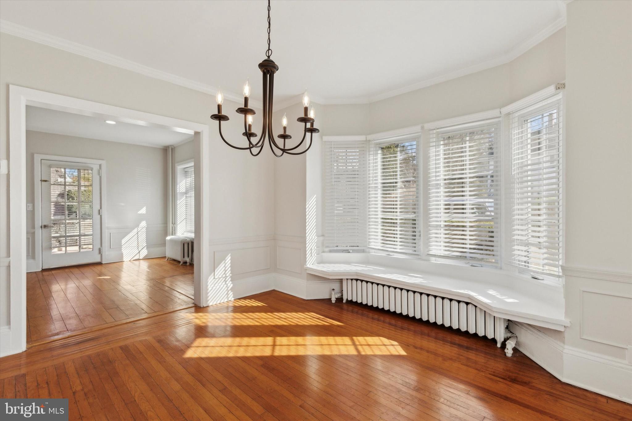 1329 Olive Street Coatesville, PA 19320 - Photo 8 of 35 a view of an empty room with wooden floor and a window