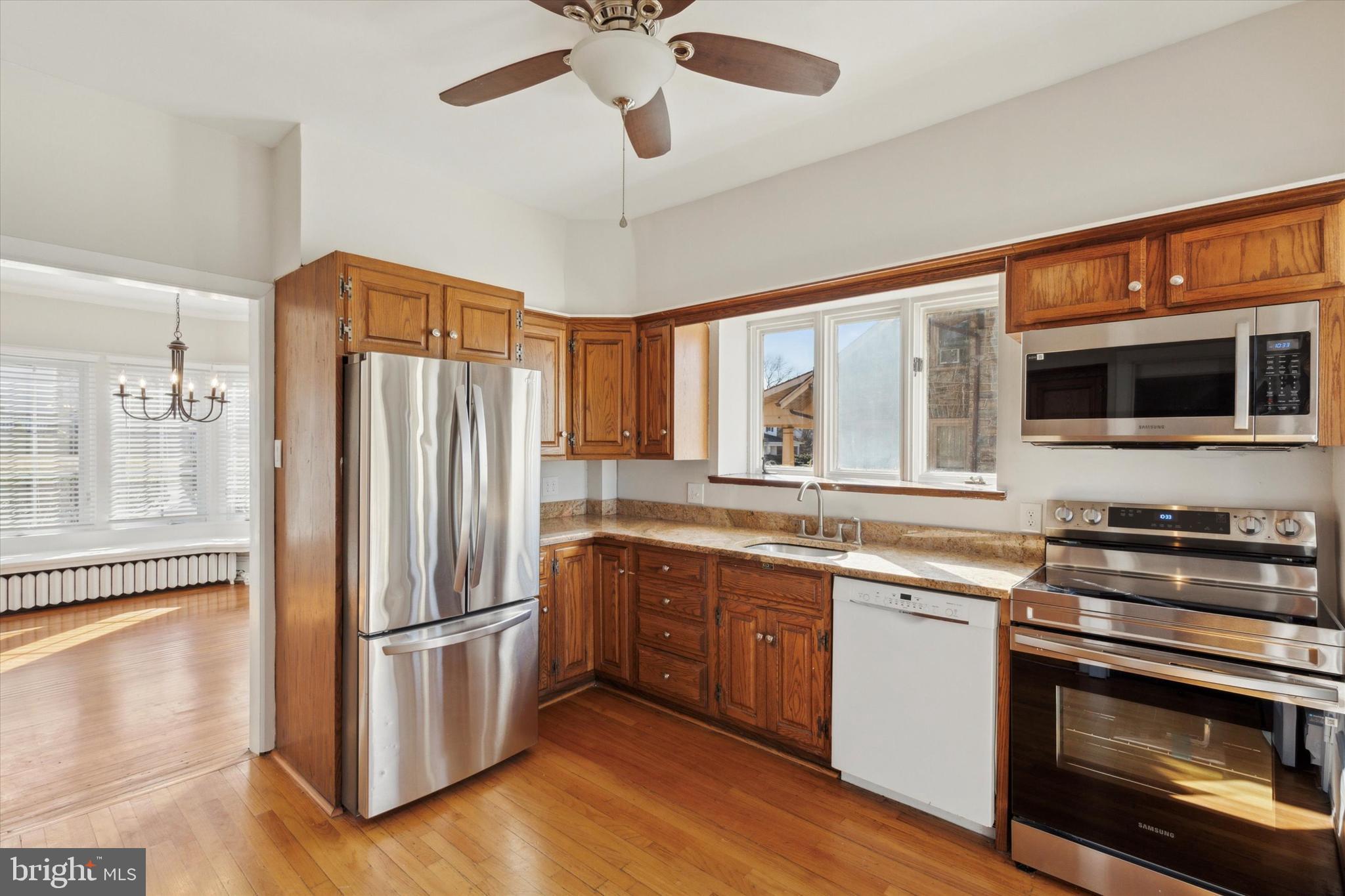 1329 Olive Street Coatesville, PA 19320 - Photo 10 of 35 a kitchen with stainless steel appliances a stove a sink and a refrigerator