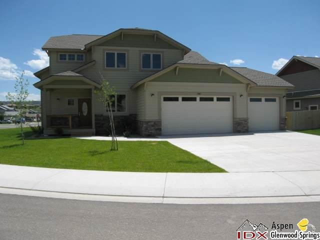 1961 Promontory Circle, Unit LOT 79 Rifle, CO 81650 - Photo 1 of 6 a front view of a house with a yard and garage