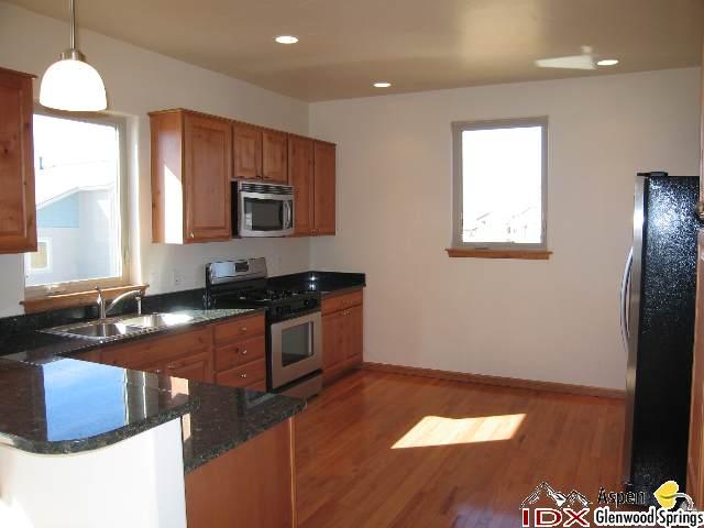 1961 Promontory Circle, Unit LOT 79 Rifle, CO 81650 - Photo 2 of 6 a kitchen with granite countertop cabinets and window