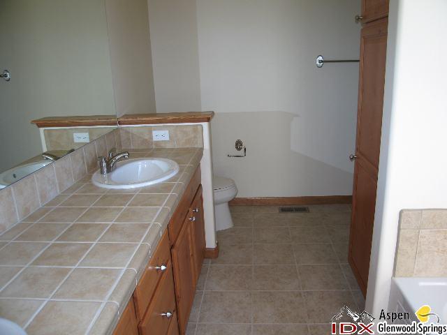 1961 Promontory Circle, Unit LOT 79 Rifle, CO 81650 - Photo 4 of 6 a bathroom with a sink and a mirror