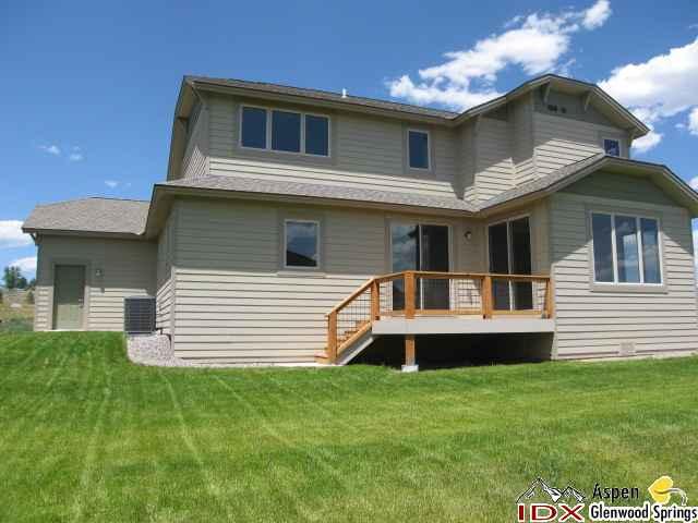 1961 Promontory Circle, Unit LOT 79 Rifle, CO 81650 - Photo 5 of 6 a front view of a house with a yard