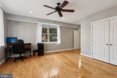 a view of workspace with wooden floor and windows
