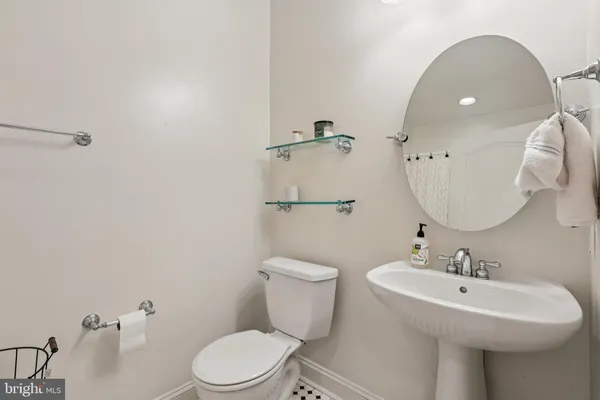 a bathroom with a toilet a sink and mirror