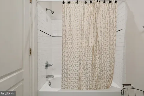 a bathroom with a bathtub and shower