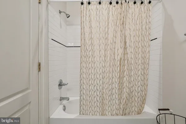 a bathroom with a bathtub and shower