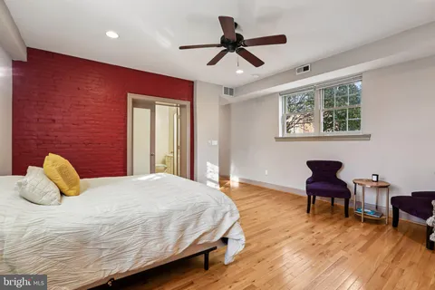 a bedroom with a bed and chair