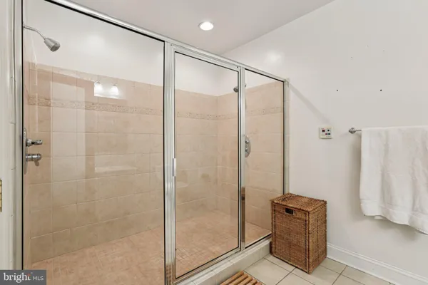 a bathroom with a shower and a glass door