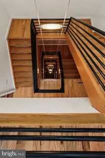 a view of a roof deck with table and chairs with wooden floor and fence