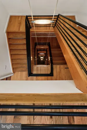 a view of a roof deck with table and chairs with wooden floor and fence