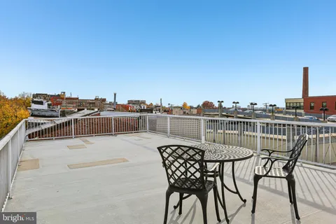 a view of a house with a deck and furniture