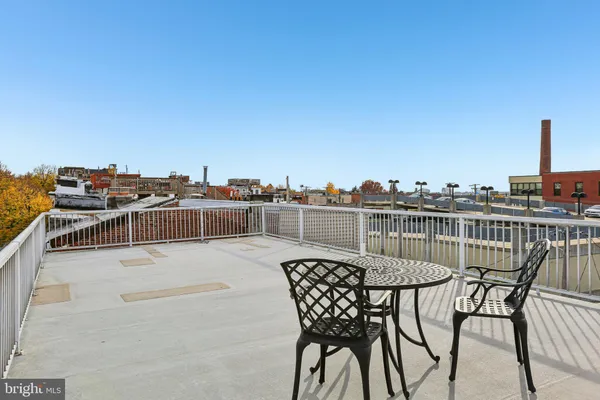 a view of a house with a deck and furniture