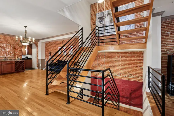 a view of entryway livingroom and hall with wooden floor