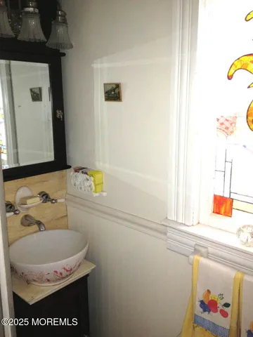 a backyard of a house with table and chairs and wooden fence