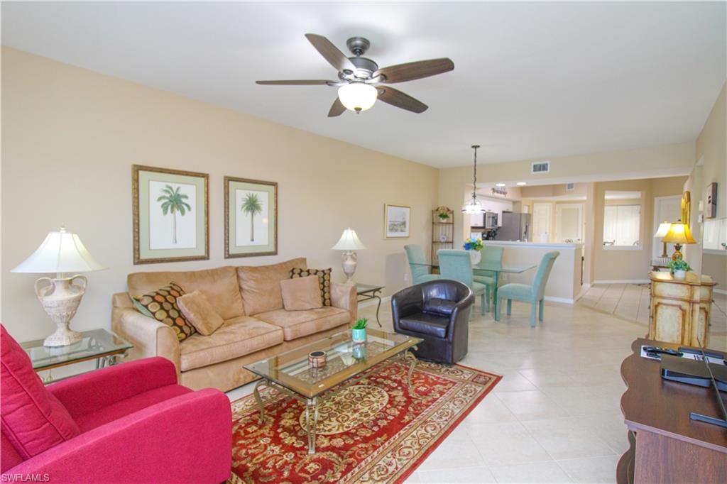 5025 Cedar Springs Drive, Unit 102 Naples, FL 34110 - Photo 13 of 50 Tiled living room with ceiling fan