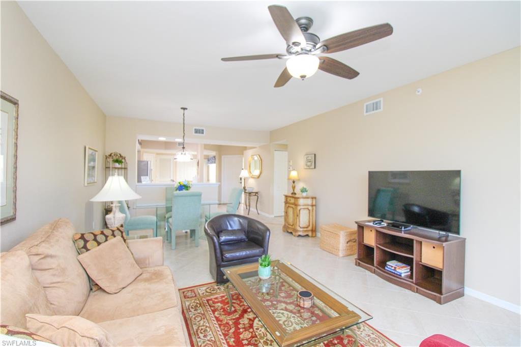 5025 Cedar Springs Drive, Unit 102 Naples, FL 34110 - Photo 14 of 50 Living room featuring tile patterned floors and ceiling fan