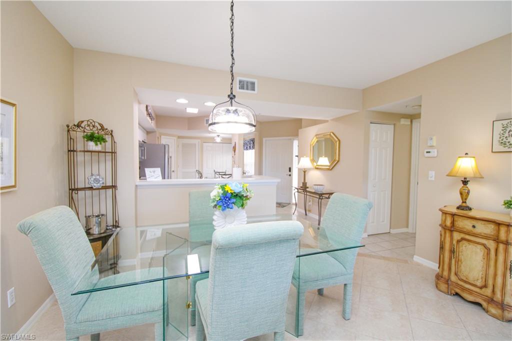 5025 Cedar Springs Drive, Unit 102 Naples, FL 34110 - Photo 15 of 50 Dining room with light tile patterned floors