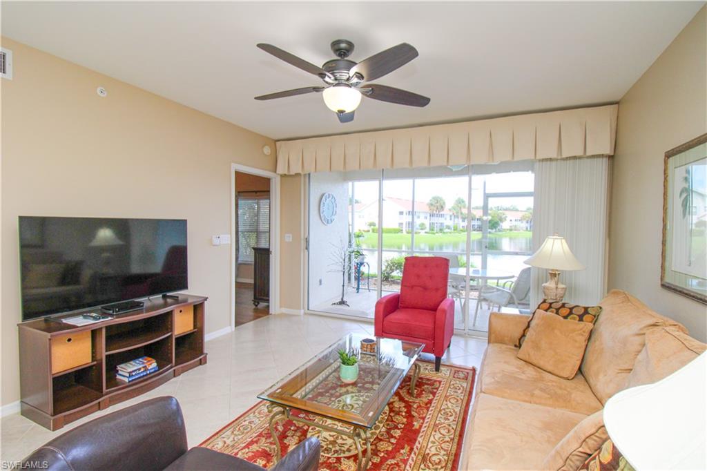 5025 Cedar Springs Drive, Unit 102 Naples, FL 34110 - Photo 16 of 50 Tiled living room featuring ceiling fan