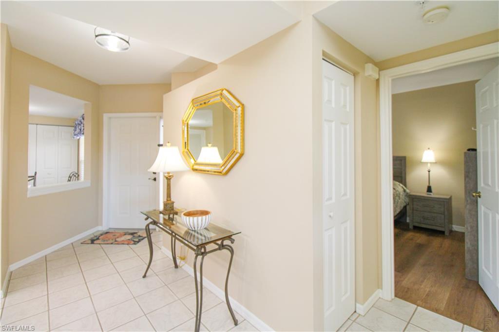 5025 Cedar Springs Drive, Unit 102 Naples, FL 34110 - Photo 19 of 50 Corridor with light tile patterned flooring