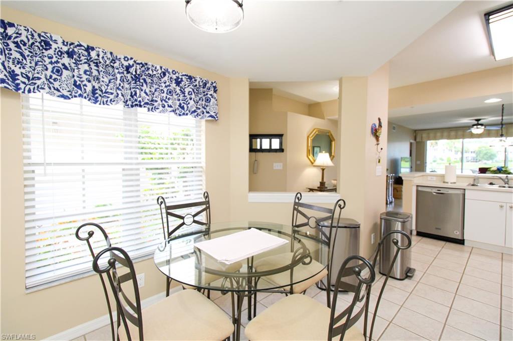 5025 Cedar Springs Drive, Unit 102 Naples, FL 34110 - Photo 28 of 50 Dining area featuring light tile patterned flooring, a healthy amount of sunlight, and ceiling fan