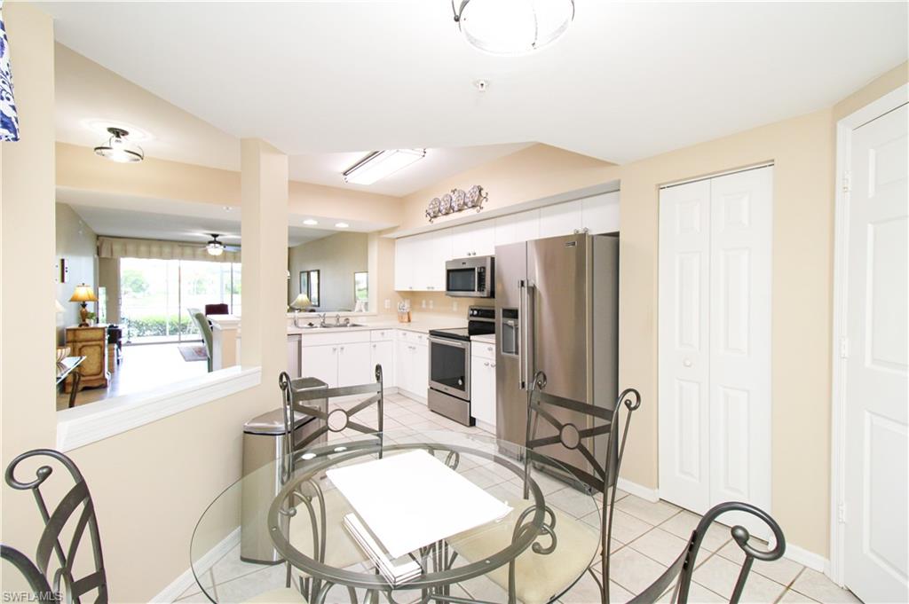 5025 Cedar Springs Drive, Unit 102 Naples, FL 34110 - Photo 29 of 50 Dining space featuring sink, light tile patterned flooring, and ceiling fan