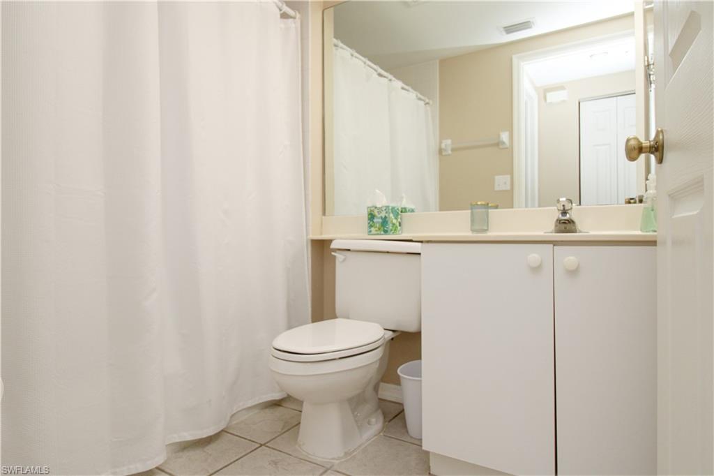 5025 Cedar Springs Drive, Unit 102 Naples, FL 34110 - Photo 31 of 50 Bathroom featuring tile patterned floors, toilet, and vanity