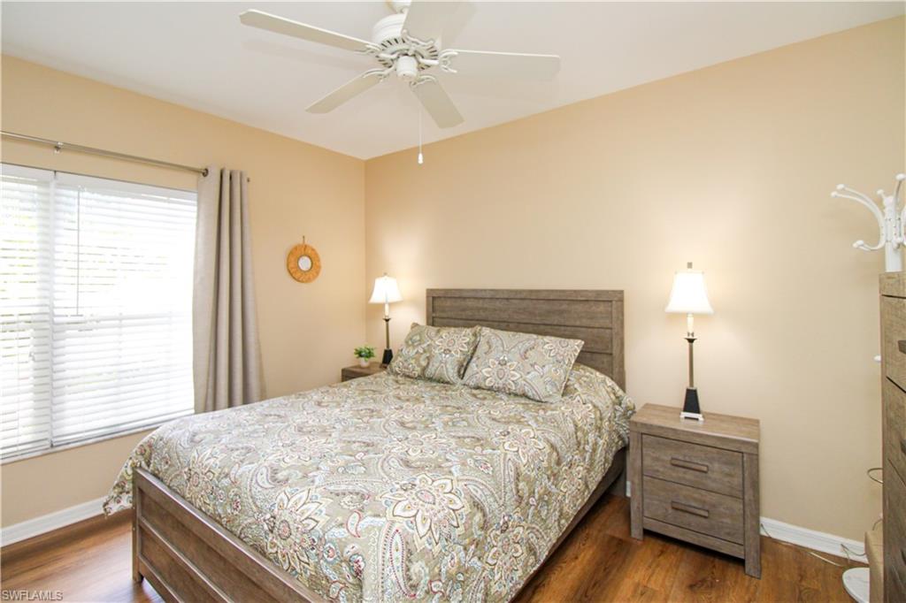 5025 Cedar Springs Drive, Unit 102 Naples, FL 34110 - Photo 33 of 50 Bedroom with dark wood-type flooring and ceiling fan