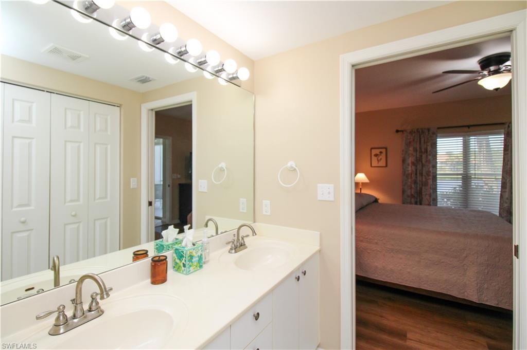 5025 Cedar Springs Drive, Unit 102 Naples, FL 34110 - Photo 40 of 50 Bathroom with hardwood / wood-style flooring, dual vanity, and ceiling fan