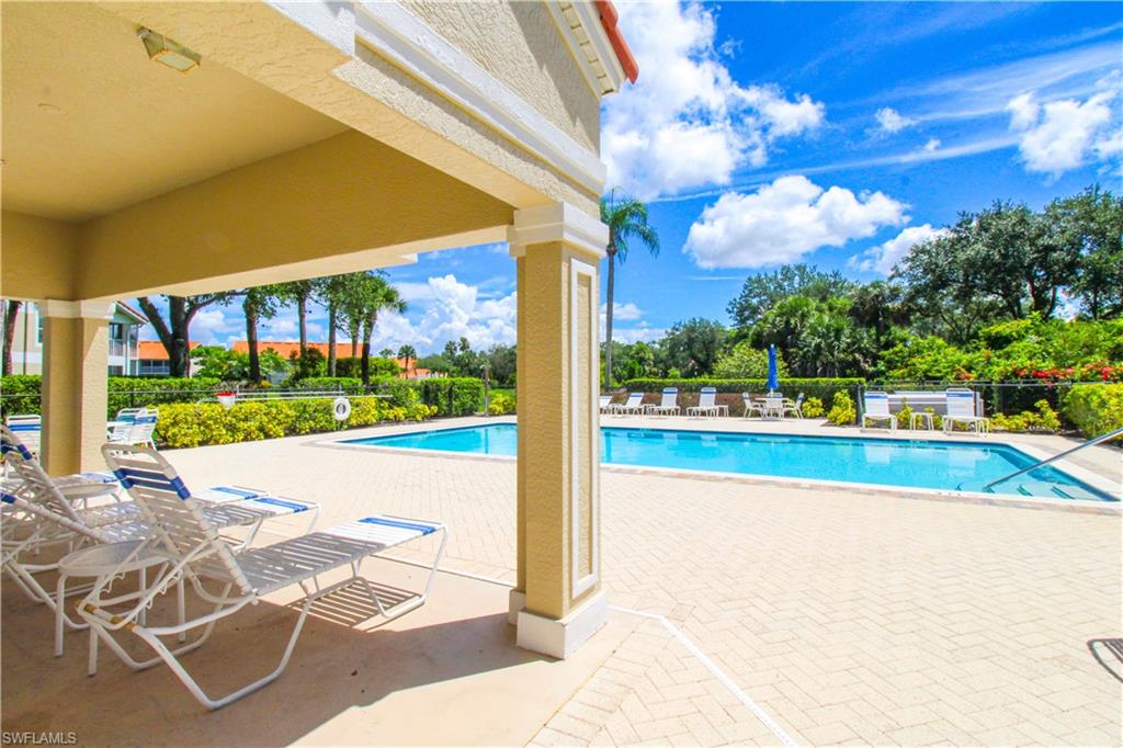 5025 Cedar Springs Drive, Unit 102 Naples, FL 34110 - Photo 43 of 50 View of swimming pool featuring a patio area