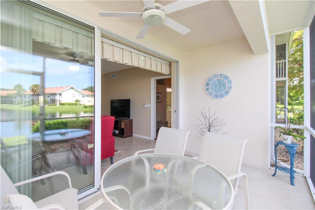 5025 Cedar Springs Drive, Unit 102 Naples, FL 34110 - Photo 7 of 50 Sunroom with a water view and ceiling fan