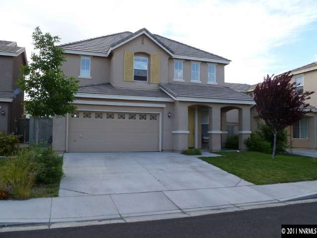 9265 Hummer Drive Reno, NV 89521 - Photo 1 of 13 a front view of a house with a garden and garage