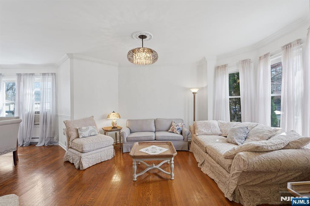 385 Berkeley Avenue Bloomfield, NJ 07003 - Photo 9 of 39 a living room with furniture wooden floor and a large window