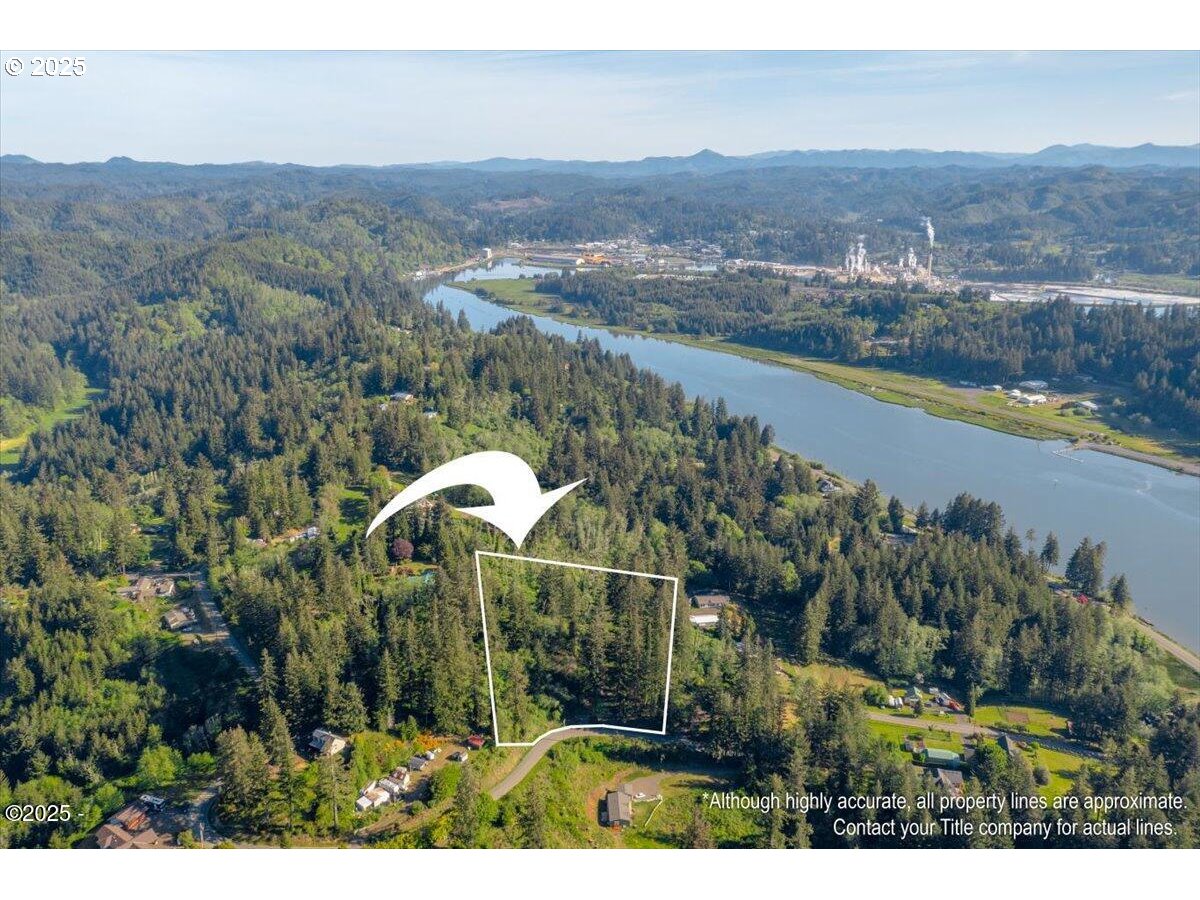 1600 Criteser Loop Toledo, OR 97391 - Photo 3 of 12 an aerial view of a house with a garden and lake view
