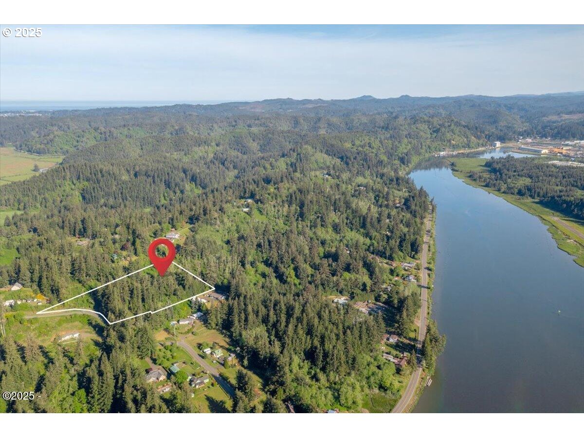 1600 Criteser Loop Toledo, OR 97391 - Photo 9 of 12 a view of a houses with a lush green forest