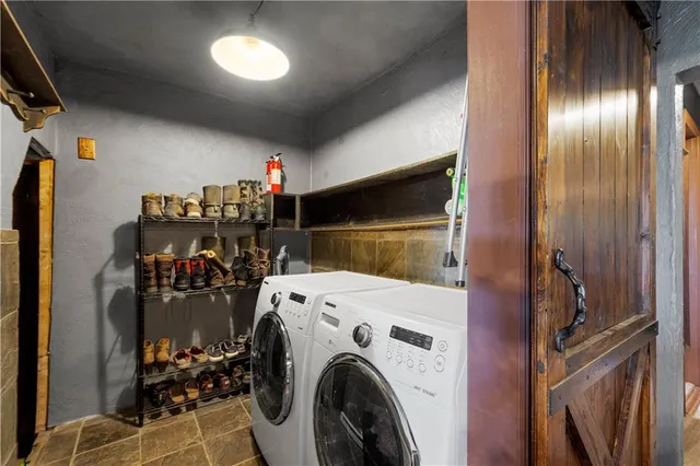 a view of a storage and utility room with washer and dryer