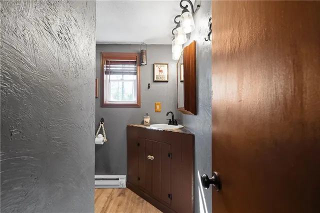 a bathroom with a granite countertop sink mirror and vanity