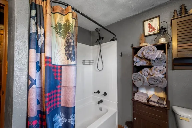 a bathroom with a bathtub and shower