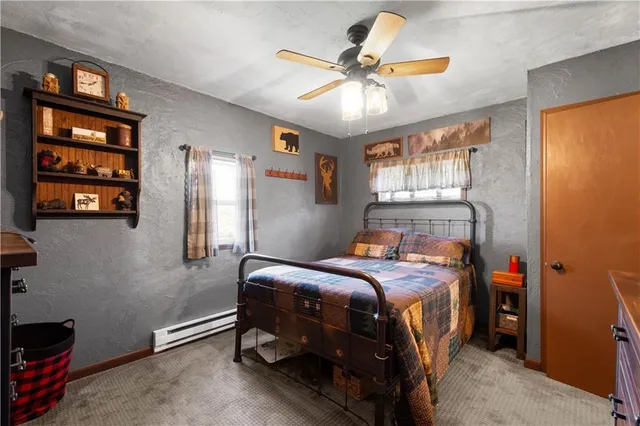 a bedroom with a bed and a ceiling fan