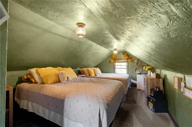 a bed sitting in a bedroom next to a window